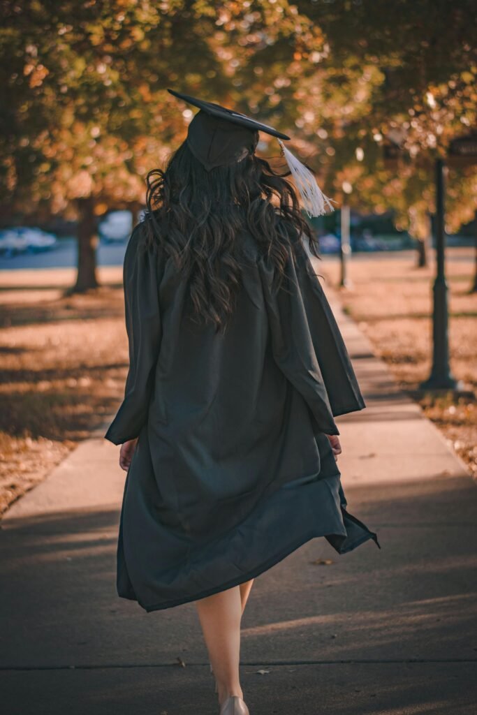 pexels-photo-3186386-3186386 Back view of a graduate walking in an autumn park in academic dress.